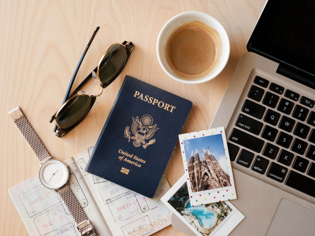 passport, watch, coffee, and laptop computer